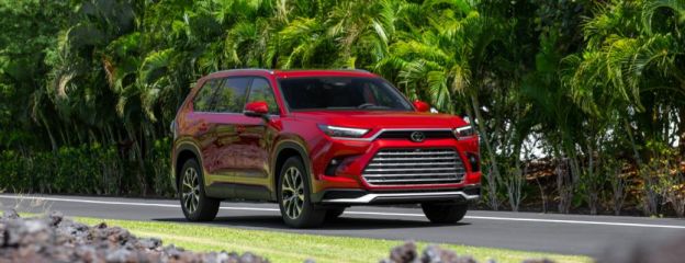 2024 Toyota Grand Highlander in red on the road